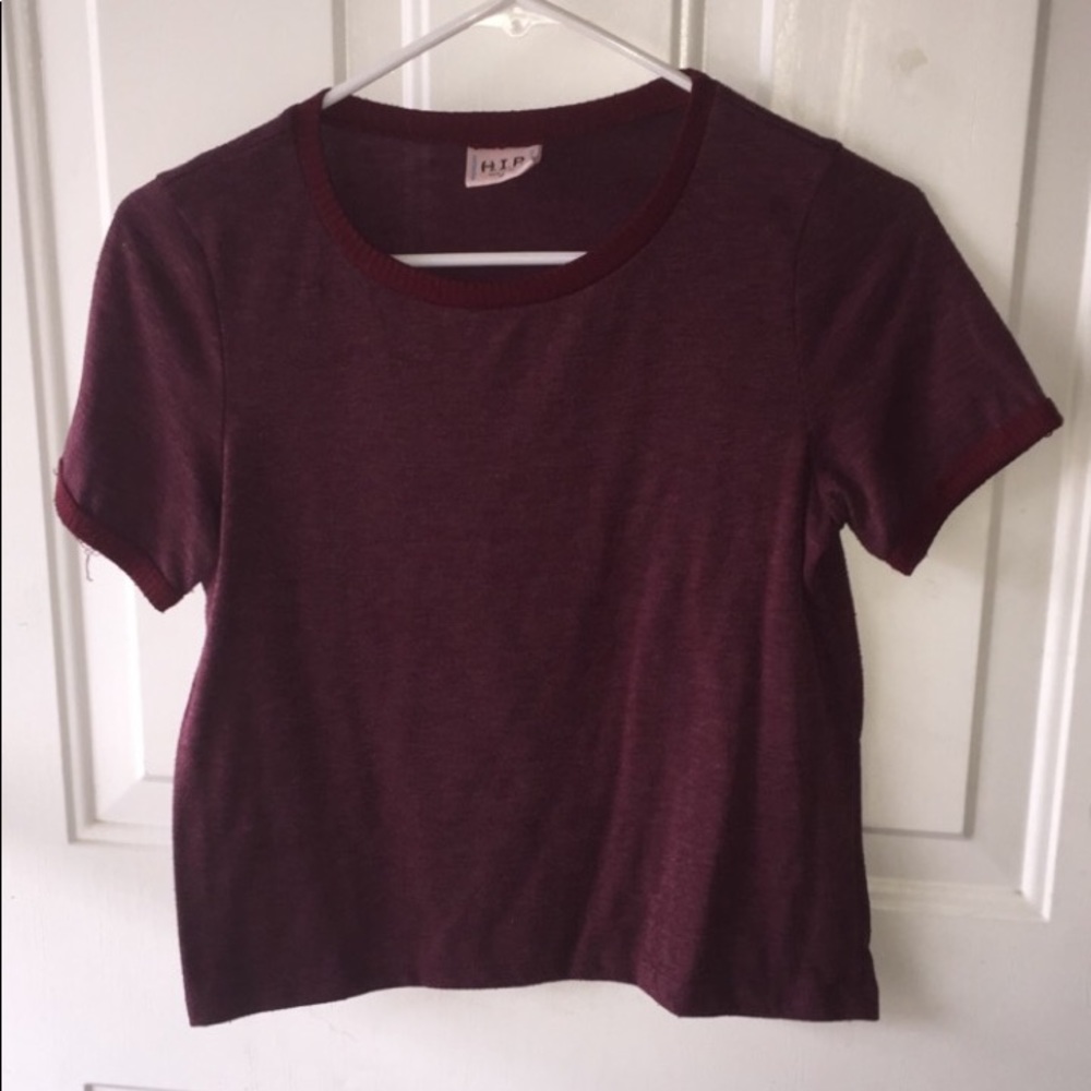 A maroon slightly cropped shirt. Fitted.